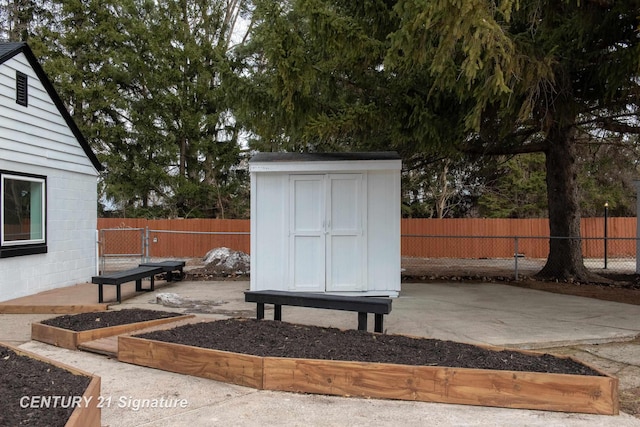 view of shed with a fenced backyard and a garden