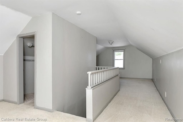 additional living space featuring vaulted ceiling, carpet, and baseboards