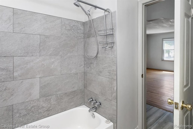 bathroom with wood finished floors and shower / bathing tub combination