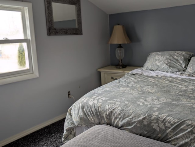 bedroom featuring carpet floors and baseboards