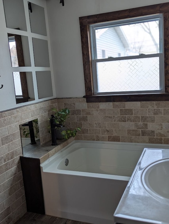 full bath featuring a sink and a bath