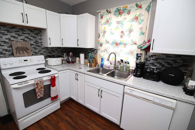 kitchen featuring white appliances, tasteful backsplash, light countertops, and a sink