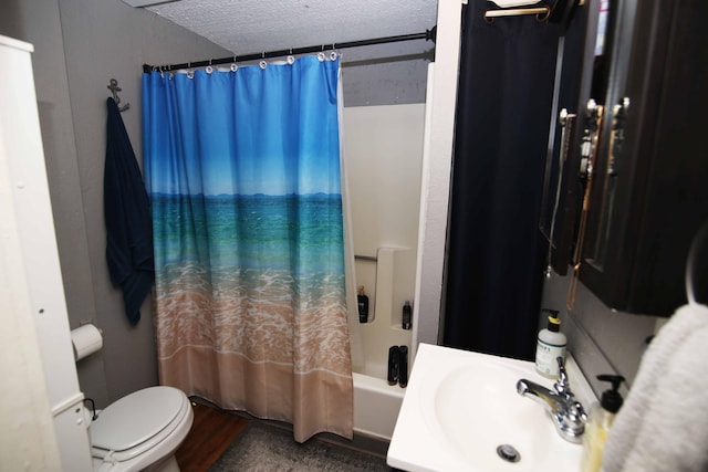 full bathroom with toilet, shower / tub combo, a textured ceiling, and a sink