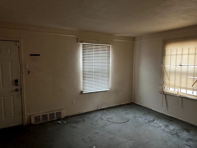 unfurnished room featuring visible vents