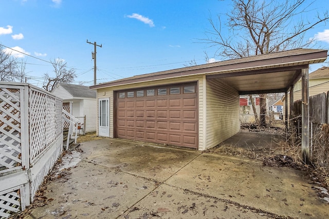 detached garage featuring fence