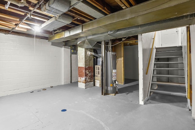 unfinished basement with water heater and stairway