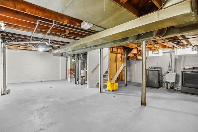 basement featuring stairs, washer / clothes dryer, gas water heater, and a sink