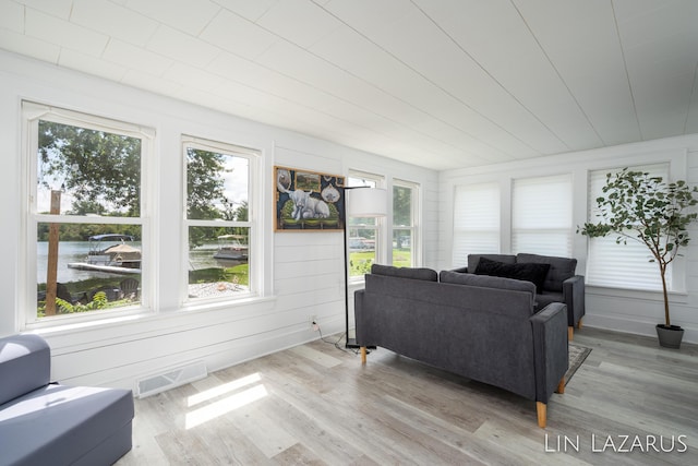 sunroom with a water view and visible vents