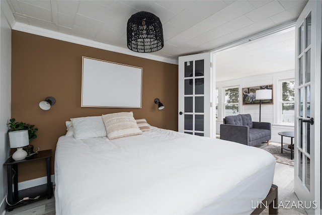 bedroom with ornamental molding, french doors, wood finished floors, and baseboards