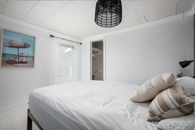 bedroom with baseboards and ornamental molding