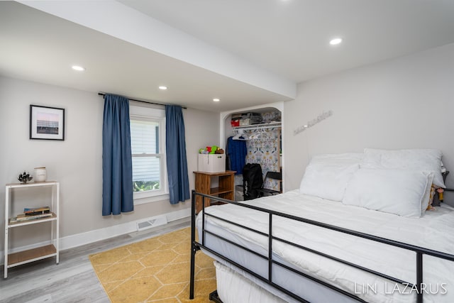 bedroom featuring recessed lighting, a closet, visible vents, wood finished floors, and baseboards