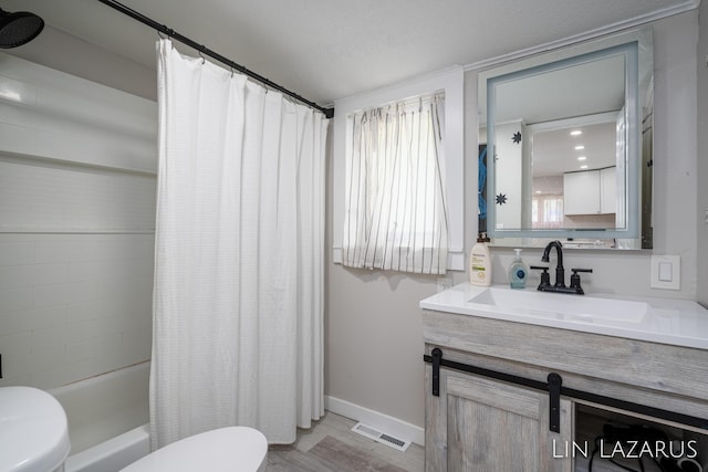 full bathroom with toilet, wood finished floors, visible vents, baseboards, and shower / bath combo