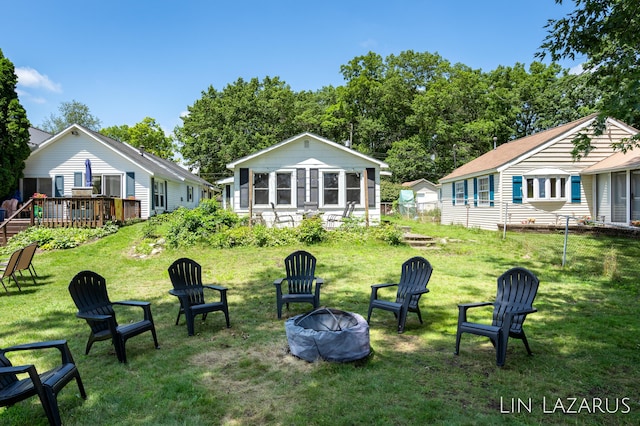 view of yard with a fire pit and a deck