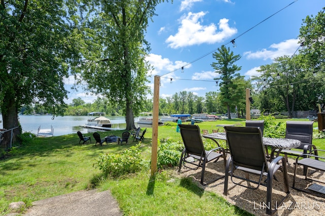 view of yard with a dock and a water view