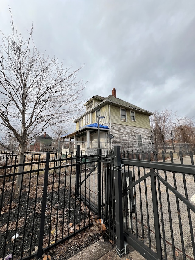 3674 Mount Elliott St, Detroit, MI 48207 - exterior space with a chimney, fence private yard, and stone siding