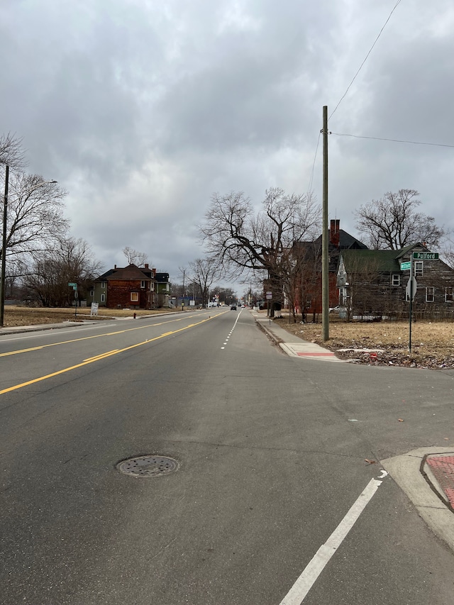 3674 Mount Elliott St, Detroit, MI 48207 - view of road with curbs, traffic signs, and sidewalks