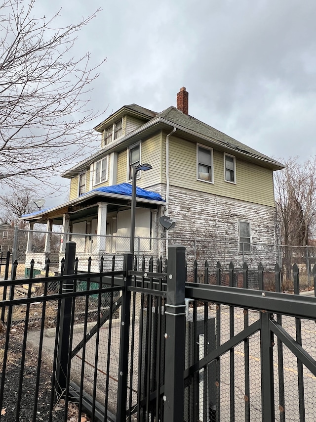 3674 Mount Elliott St, Detroit, MI 48207 - view of front of property featuring a gate, a chimney, and fence private yard