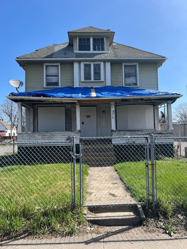 3674 Mount Elliott St, Detroit, MI 48207 - american foursquare style home featuring a gate, covered porch, a fenced front yard, and a front yard