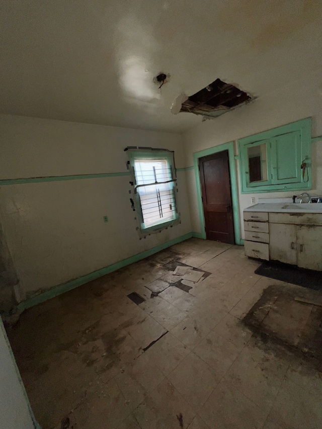 3674 Mount Elliott St, Detroit, MI 48207 - unfurnished bedroom with baseboards and a sink