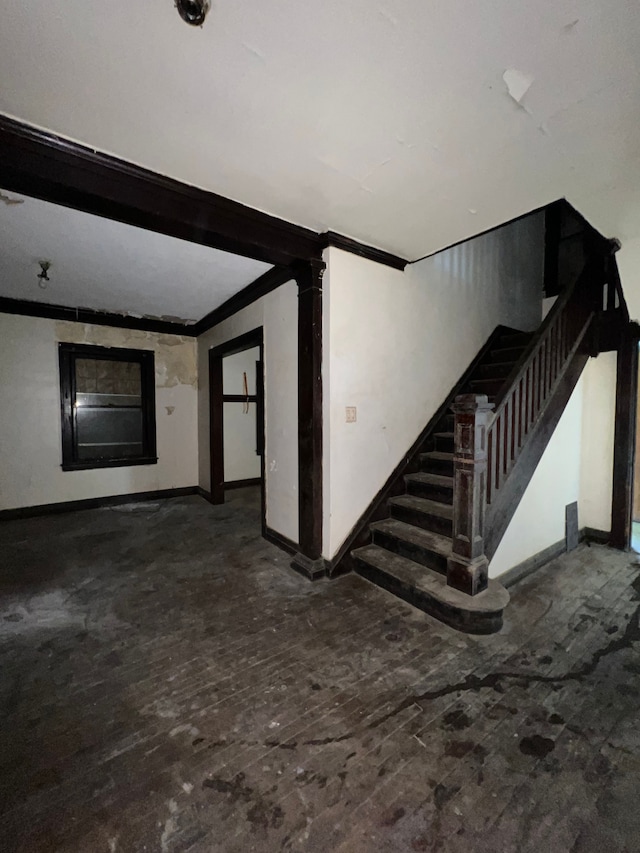 3674 Mount Elliott St, Detroit, MI 48207 - unfurnished living room featuring baseboards, stairs, and crown molding