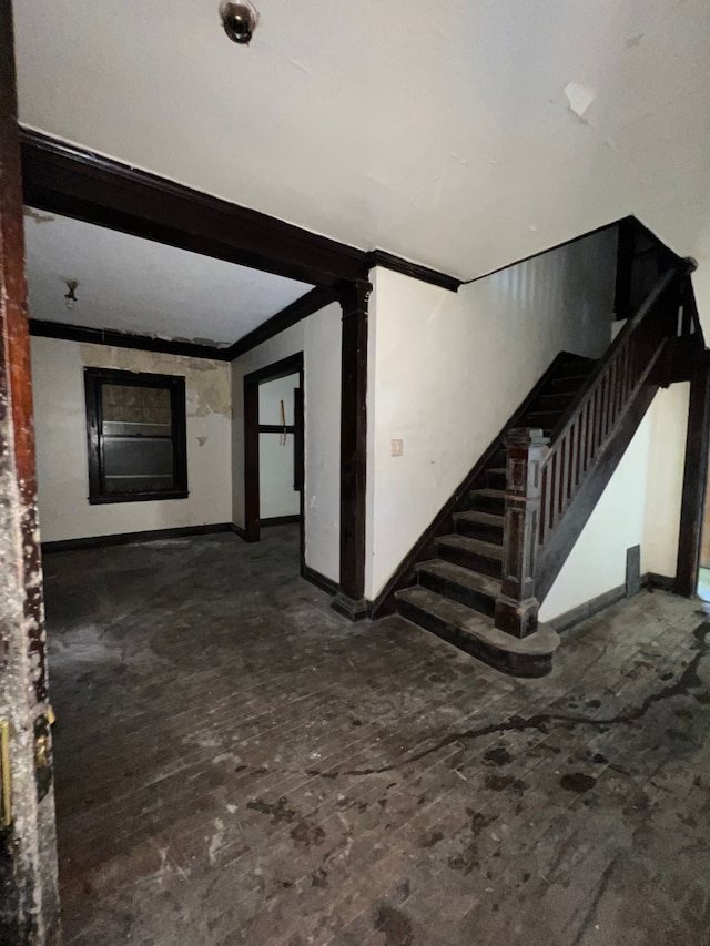 3674 Mount Elliott St, Detroit, MI 48207 - unfurnished living room featuring baseboards, ornamental molding, and stairs