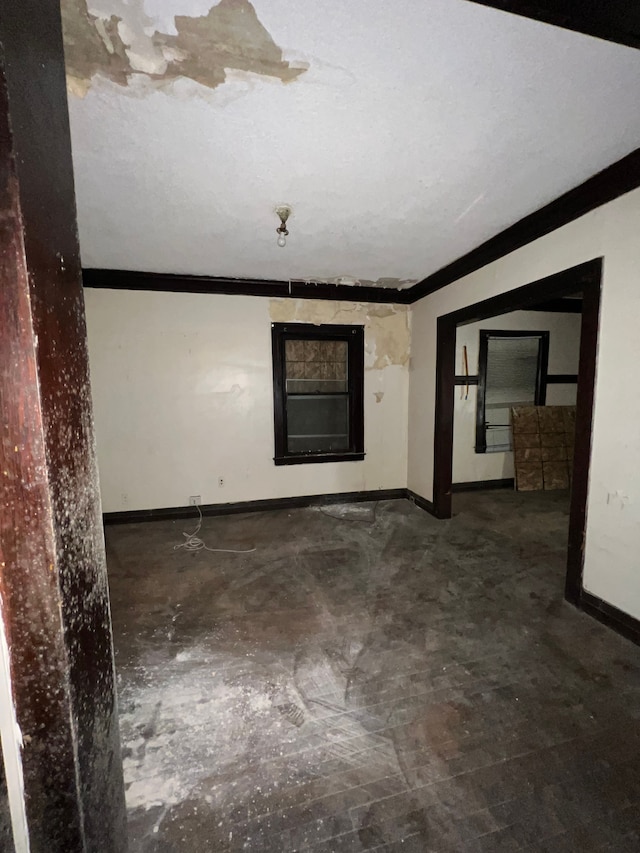 3674 Mount Elliott St, Detroit, MI 48207 - spare room with crown molding, baseboards, and concrete flooring