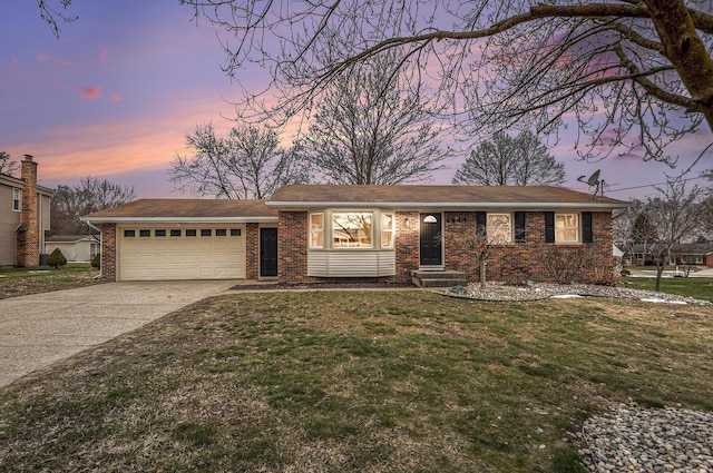 single story home with concrete driveway, brick siding, an attached garage, and a front yard