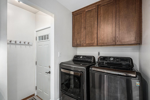 laundry area with washer and clothes dryer, cabinet space, and baseboards