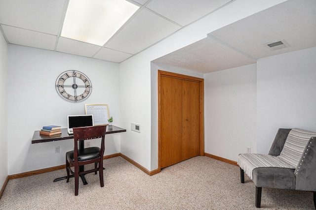 office space featuring a drop ceiling, carpet flooring, visible vents, and baseboards