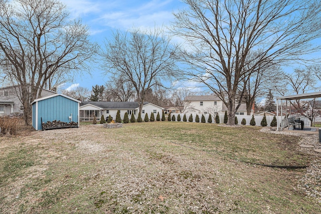 view of yard with an outdoor structure and fence