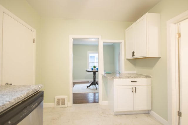 kitchen with visible vents, baseboards, white cabinetry, marble finish floor, and dishwasher