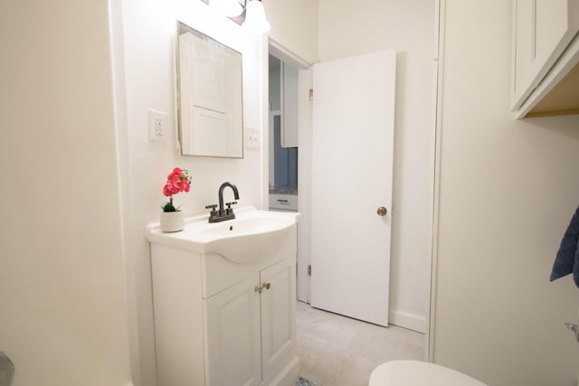 bathroom featuring toilet and vanity