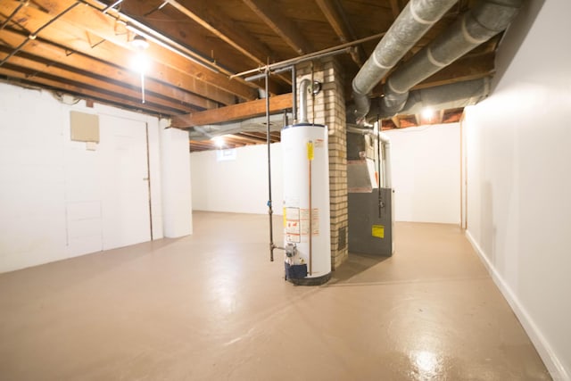 unfinished below grade area featuring gas water heater and heating unit