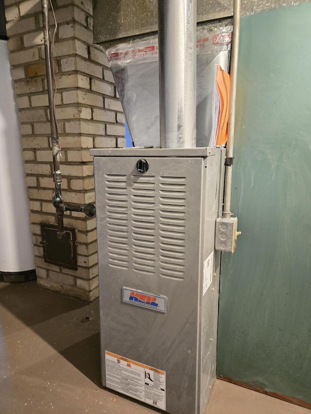 utility room featuring water heater