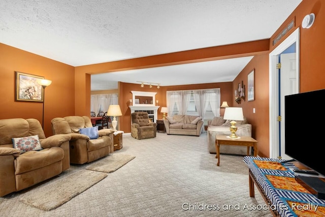 carpeted living room with a fireplace and a textured ceiling