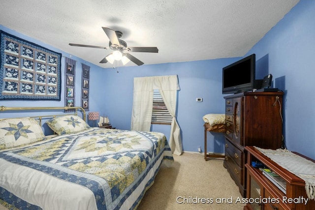 bedroom featuring carpet floors, baseboards, a ceiling fan, and a textured ceiling