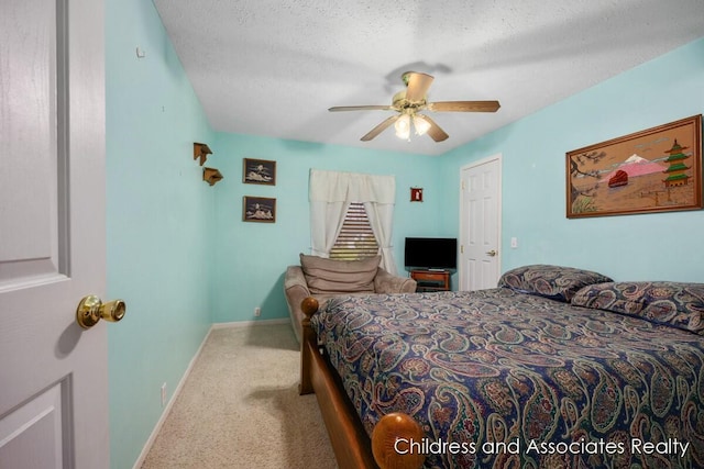 bedroom featuring a textured ceiling, carpet, a ceiling fan, and baseboards