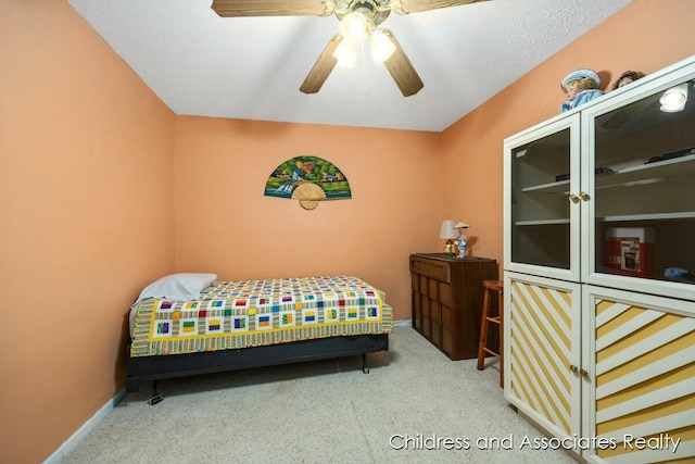 bedroom with a ceiling fan, baseboards, and carpet flooring