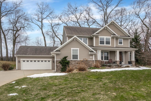 craftsman-style house featuring a garage, concrete driveway, stone siding, covered porch, and a front lawn