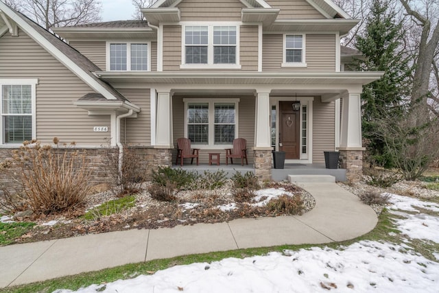 view of front facade featuring a porch and stone siding