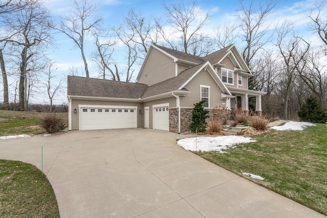 view of front of house with roof with shingles, concrete driveway, a front yard, a garage, and stone siding