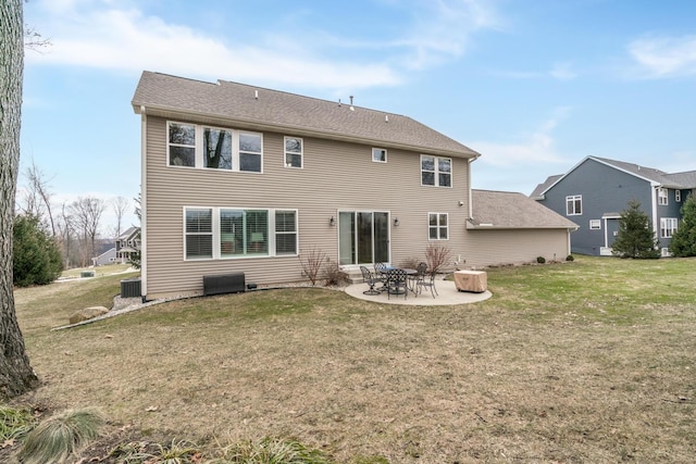 rear view of house with a yard, a patio, and central AC unit