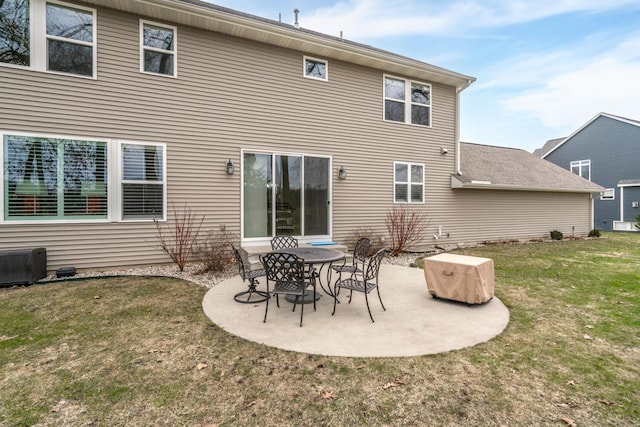 rear view of property with a yard, central AC unit, and a patio