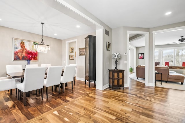 dining room with light wood-style floors, recessed lighting, baseboards, and ceiling fan with notable chandelier