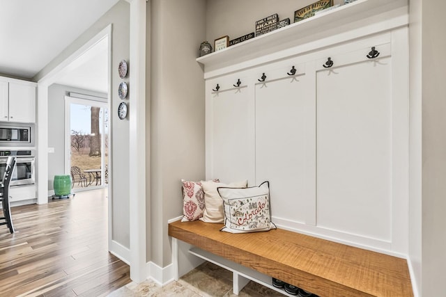 mudroom with light wood-type flooring and baseboards