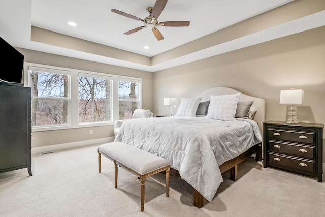 bedroom with light colored carpet, visible vents, baseboards, and multiple windows