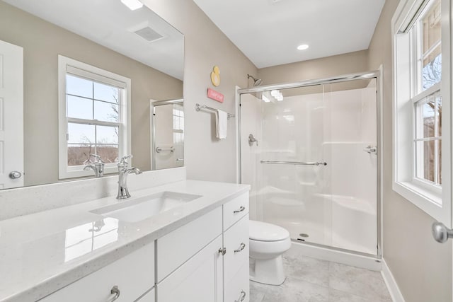 bathroom featuring toilet, a stall shower, vanity, and visible vents