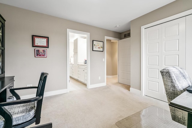 carpeted office space with visible vents and baseboards