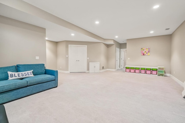 living room with recessed lighting, light colored carpet, and baseboards