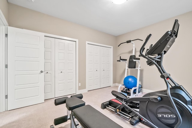 workout area with carpet flooring and baseboards